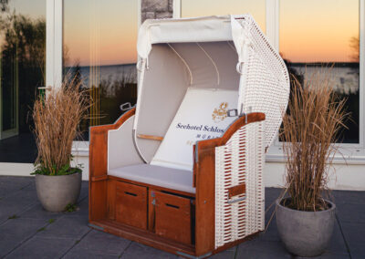 Strandkorb auf der Terrasse bei Abendlicht.